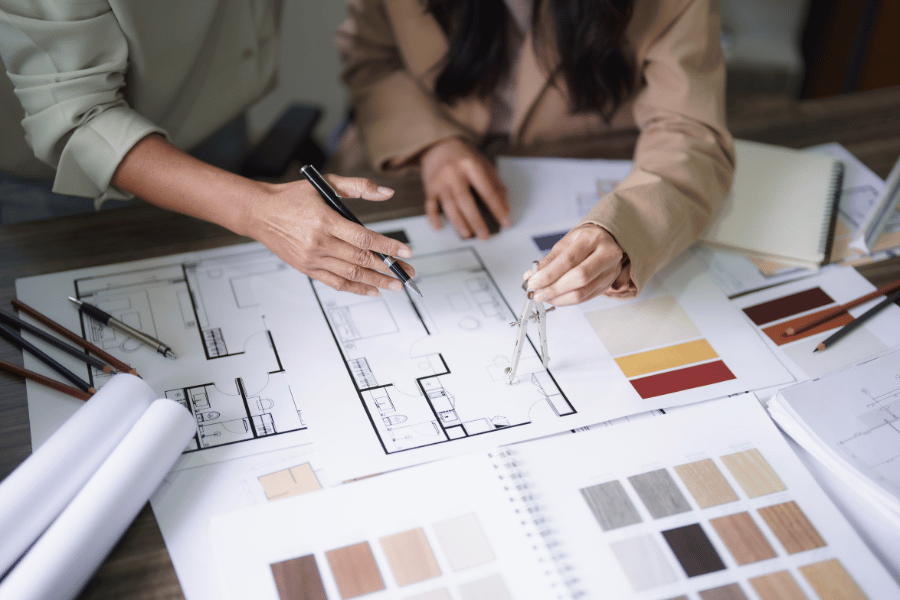 Office renovation professionals reviewing floor plans and design materials